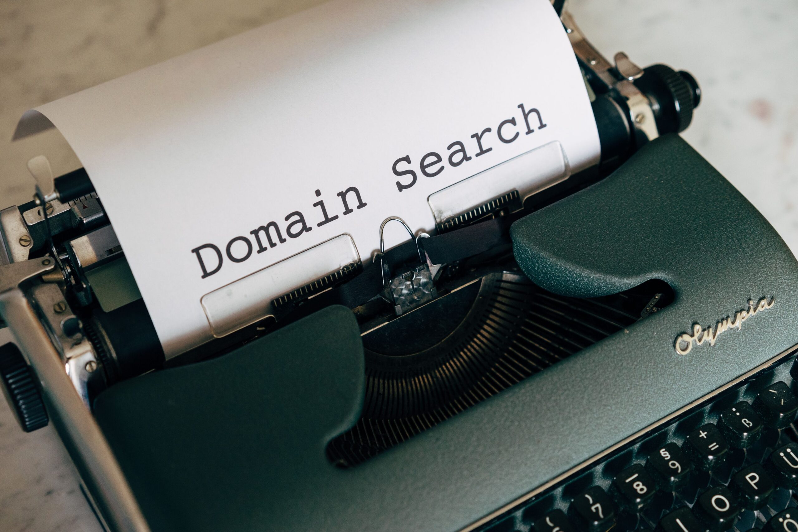 Vintage typewriter typing the words Domain Search, representing finding and vetting the best guest posting sites